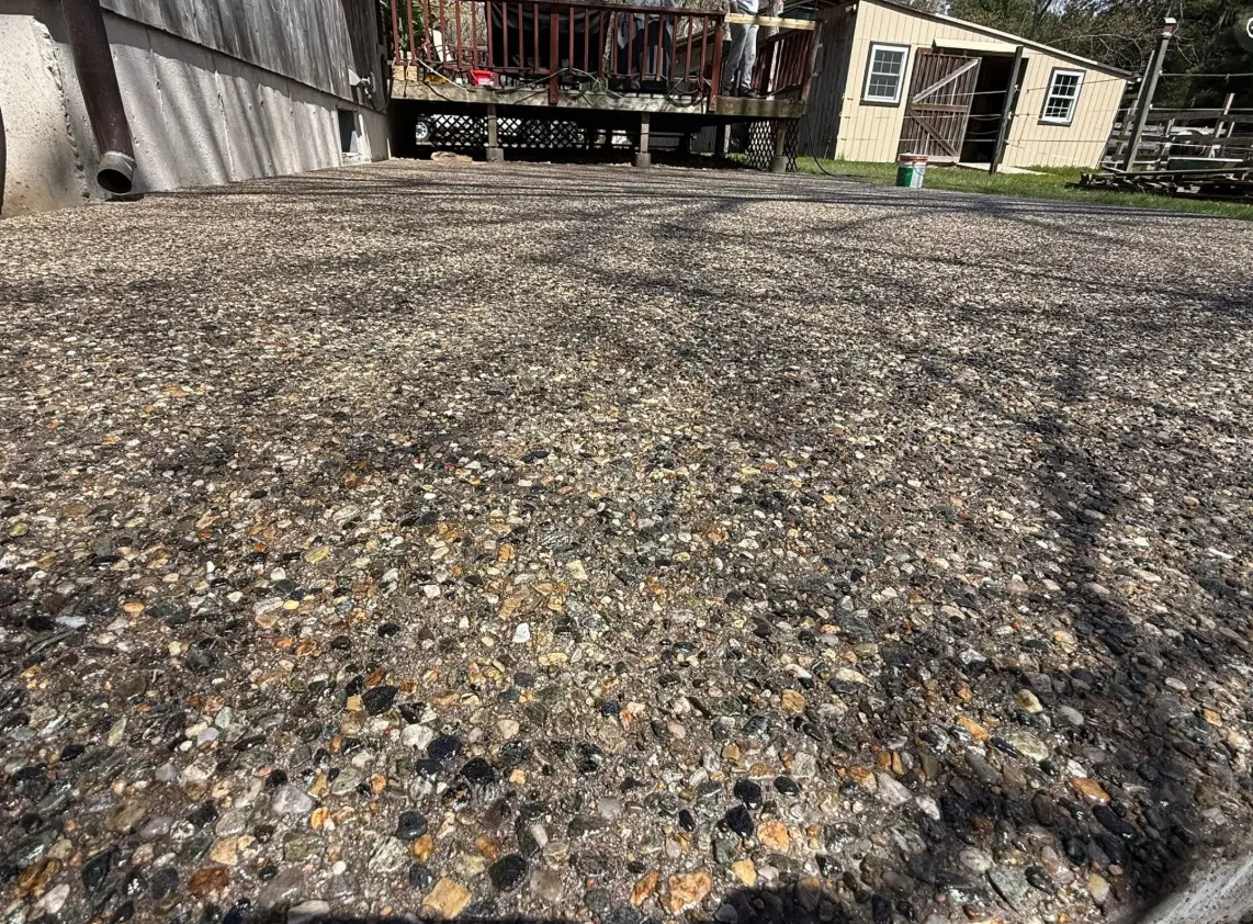 Close-up of an exposed-aggregate concrete surface showing embedded stones
